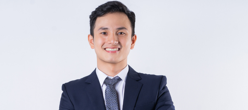 A man wearing formal wear in an office representing a sales representative 